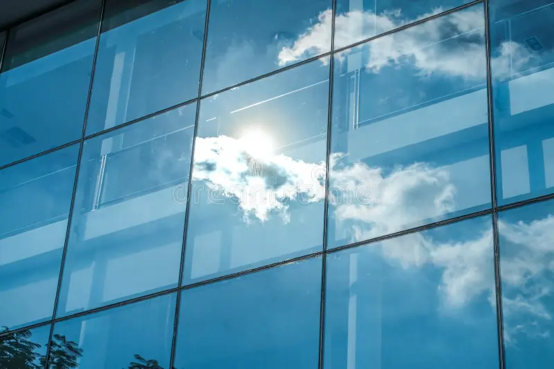 sun-ray-blue-sky-reflection-window-office-building-busin-business-concept-94156675.webp